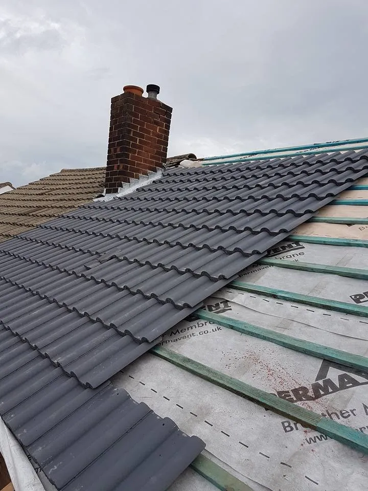 Roofer replacing broken tiles on a {service area} terraced house
